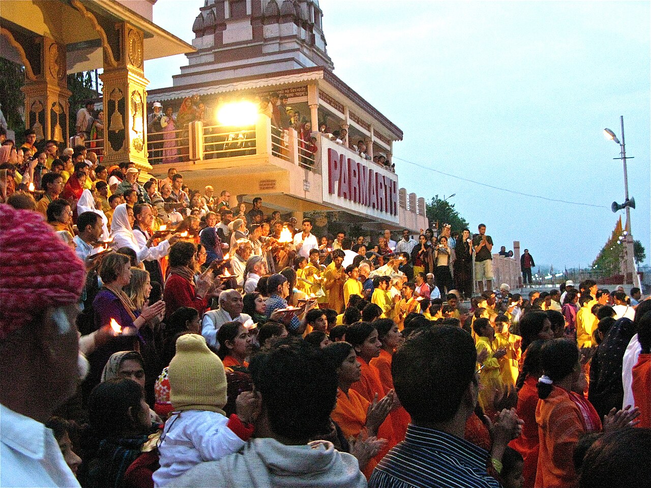 Lamps raised at the Ganga Aarti at dusk